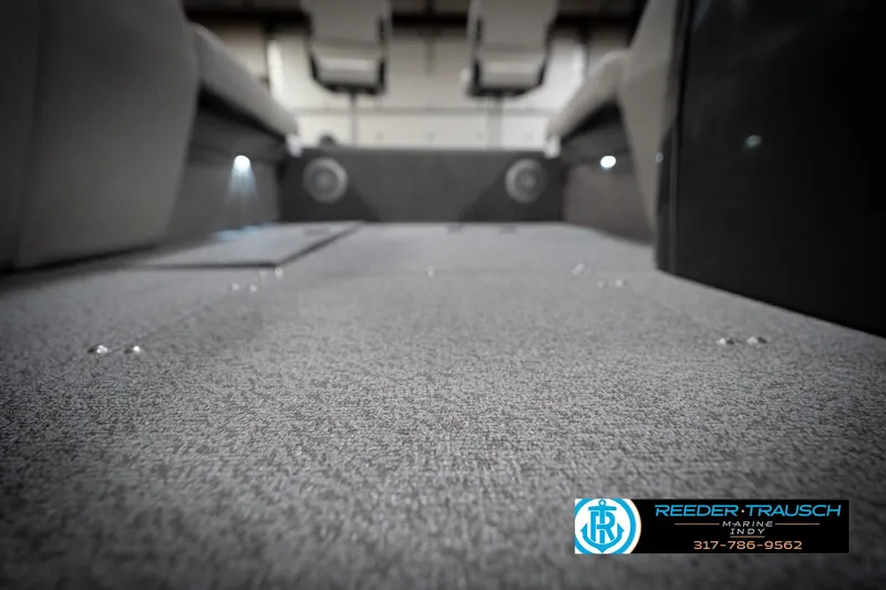 Slide: The Image of Carpeted interior of a 2022 Flowers SD224 boat, featuring ambient lighting and seating. - 52