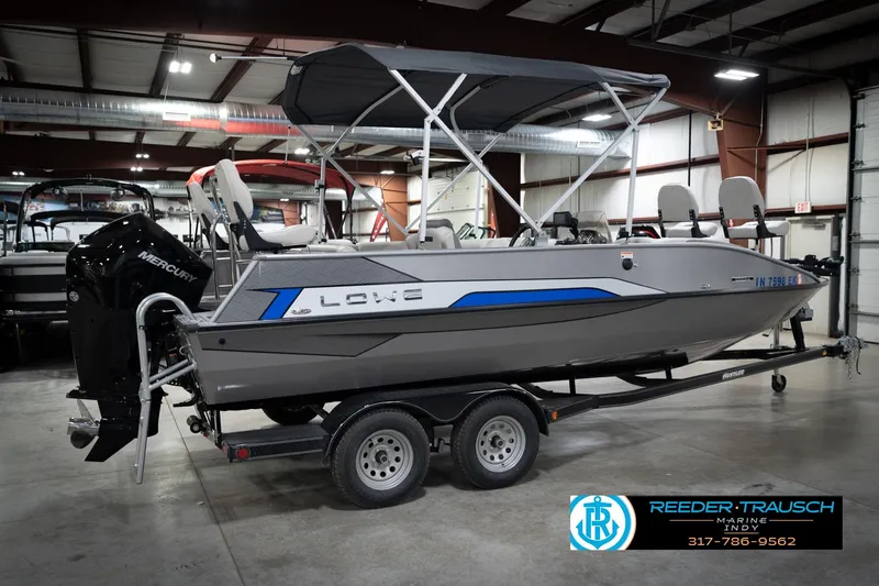 Slide: The Image of 2022 Lowe SD224 boat with Mercury engine on trailer in indoor showroom. - 6