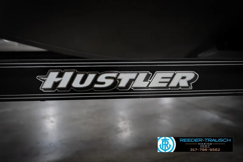 Slide: The Image of Close-up of 'Hustler' logo on black surface, Reeder Trausch Marine branding visible. - 62