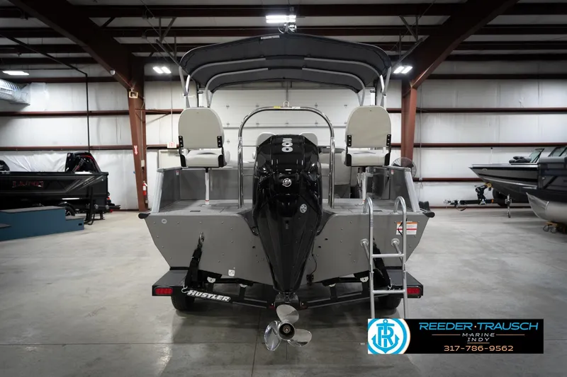 Slide: The Image of Rear view of a 2022 Flowers SD224 boat in a warehouse, featuring a powerful outboard motor. - 7