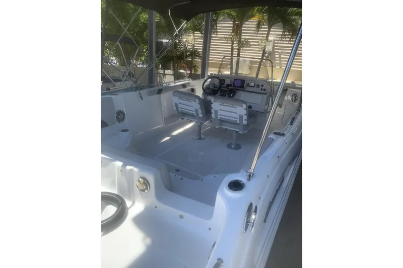 Slide: The Image of 2024 Hurricane CC231 boat interior with dual seats and modern dashboard. - 2