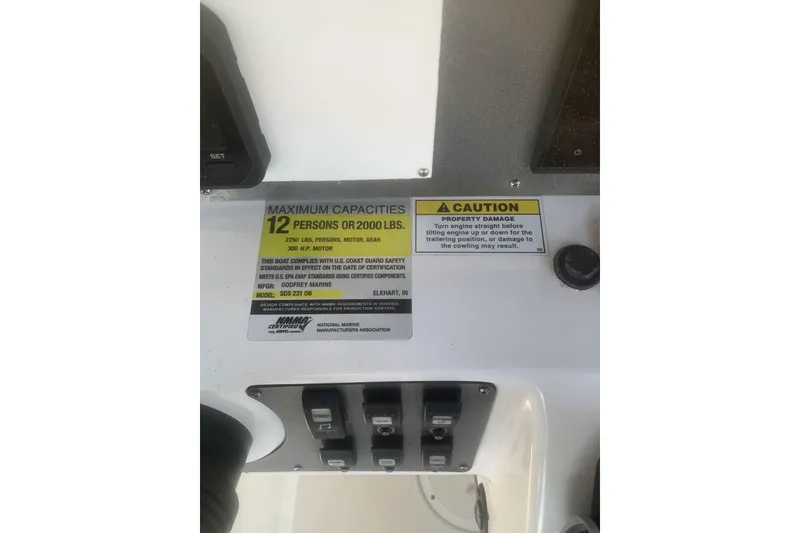 Slide: The Image of Control panel of 2024 Hurricane CC231 boat, showing capacity and caution labels. - 3