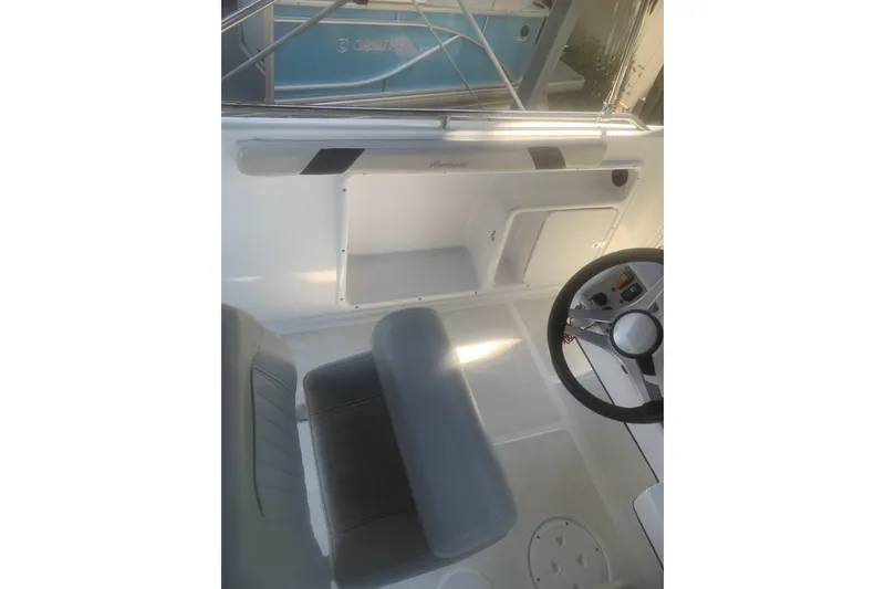 Slide: The Image of 2024 Hurricane CC231 boat interior with steering wheel and seating area. - 5