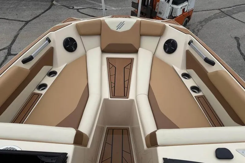 Slide: The Image of 2024 ATX Surf Boats 24 Type-S interior with tan and cream seating, cup holders, and speakers. - 14