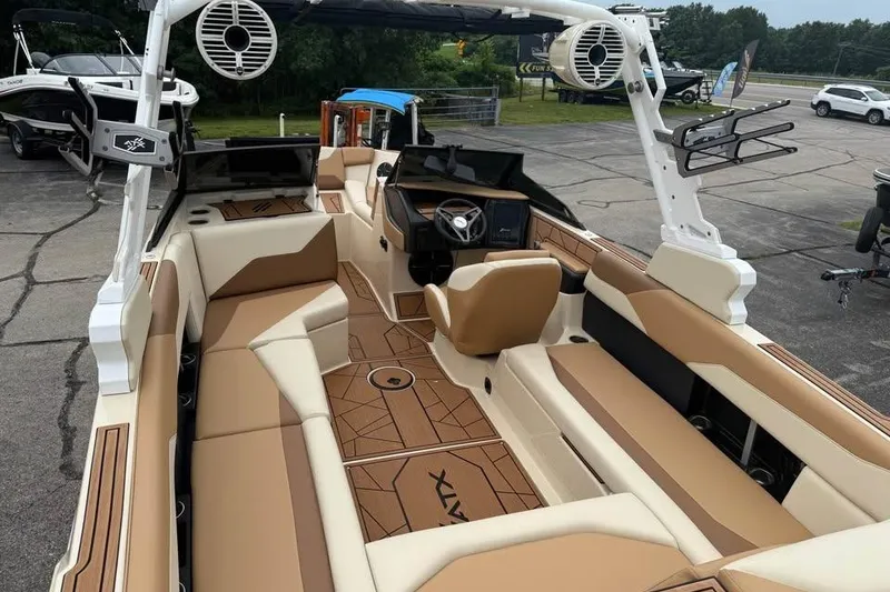 Slide: The Image of 2024 ATX Surf Boats 24 Type-S interior with tan seating and modern dashboard. - 9