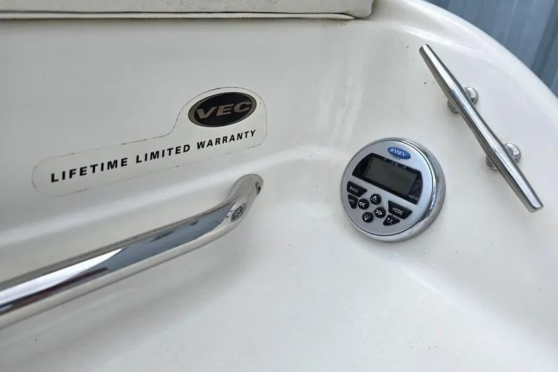 Slide: The Image of 2008 Glastron GT205 BR boat interior with VEC warranty label and Jensen control panel. - 14