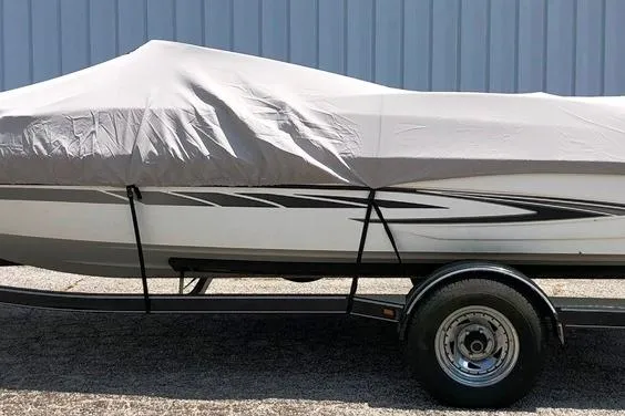 Slide: The Image of 2008 Glastron GT205 BR boat covered on trailer, parked outdoors. - 18