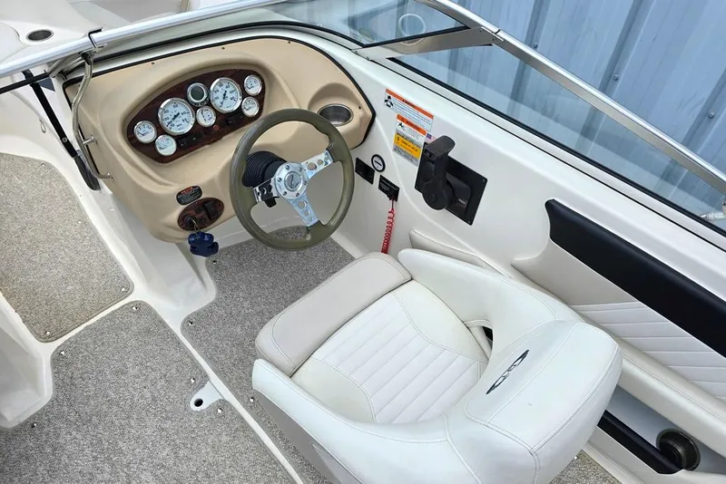Slide: The Image of 2008 Glastron GT205 BR boat cockpit with steering wheel and dashboard controls. - 2