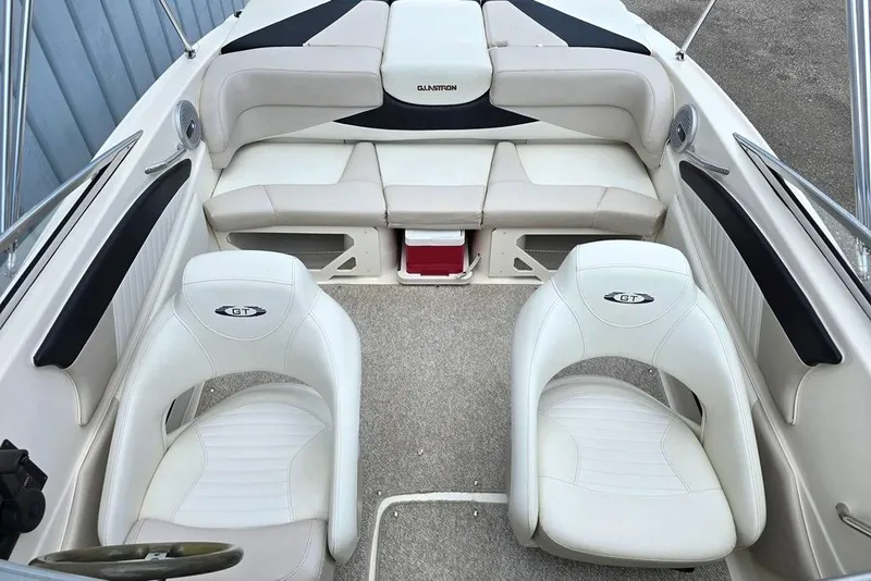 Slide: The Image of 2008 Glastron GT205 BR boat interior with white seating and steering wheel. - 4