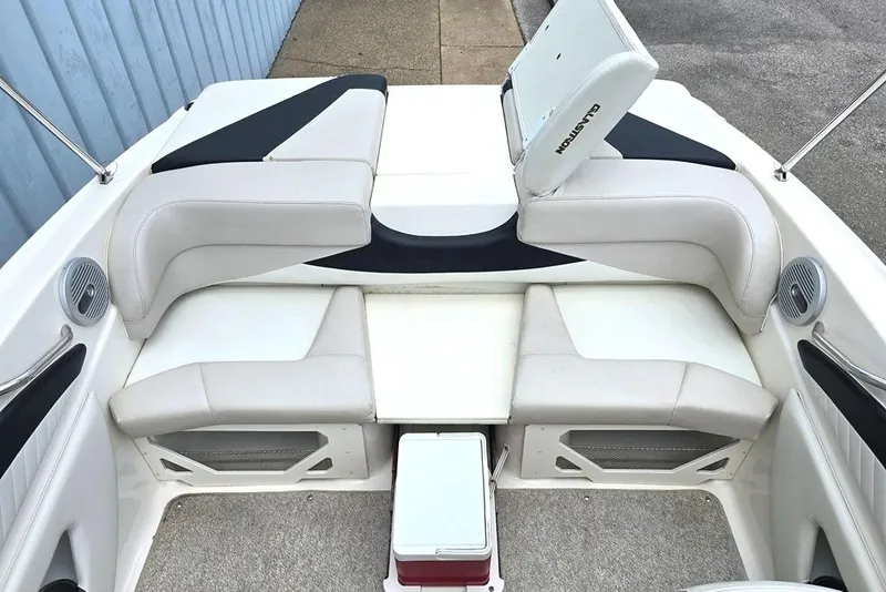 Slide: The Image of 2008 Glastron GT205 BR boat interior with white seating and storage compartments. - 5