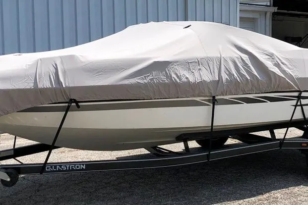 Slide: The Image of 2008 Glastron GT205 BR boat covered on trailer, parked outdoors. - 8