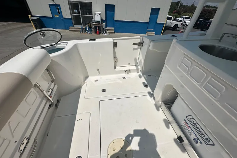 Slide: The Image of 2023 Robalo R302 Center Console boat interior with seating and storage compartments. - 10