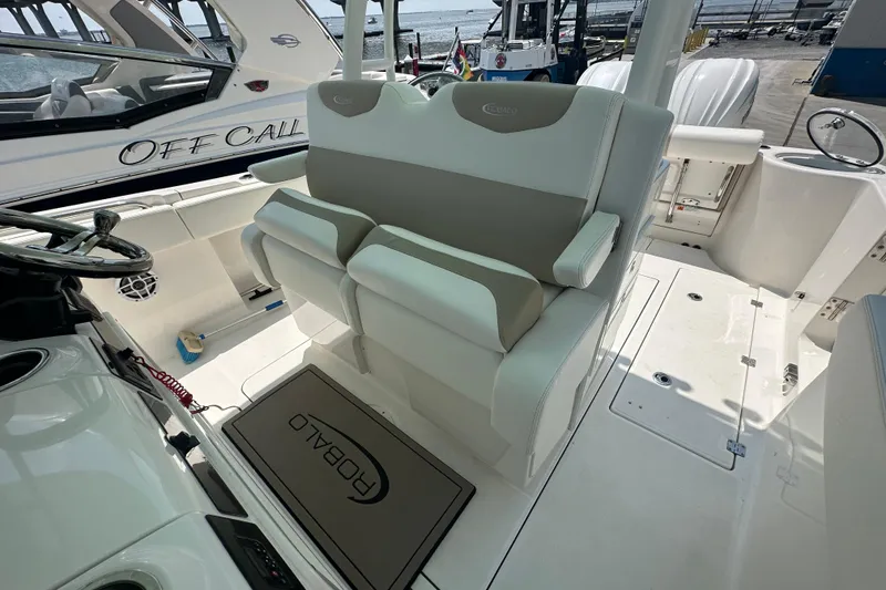 Slide: The Image of 2023 Robalo R302 Center Console boat interior with dual seating and steering wheel. - 13