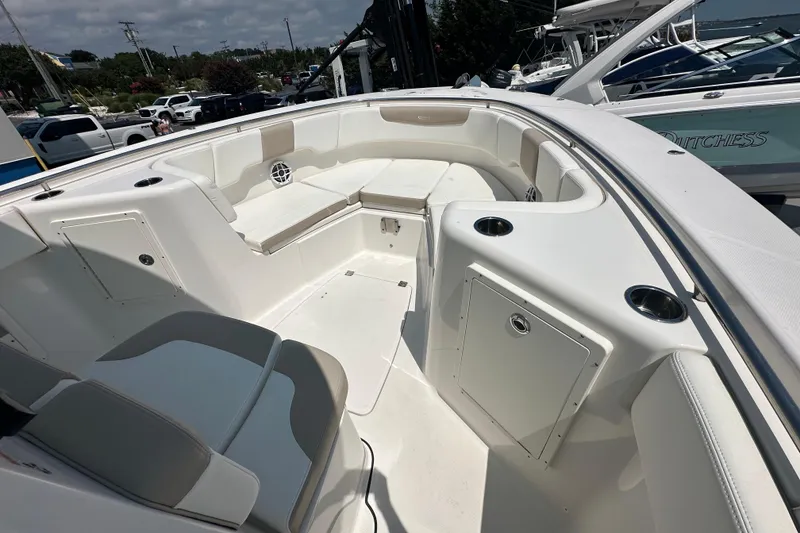 Slide: The Image of 2023 Robalo R302 Center Console boat interior with seating and storage compartments. - 14