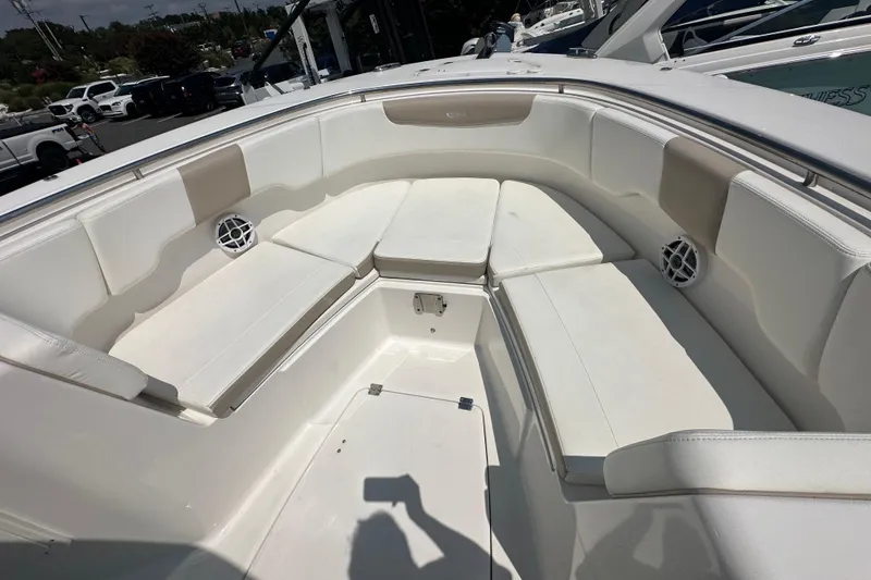 Slide: The Image of 2023 Robalo R302 Center Console boat interior with cushioned seating and speakers. - 17