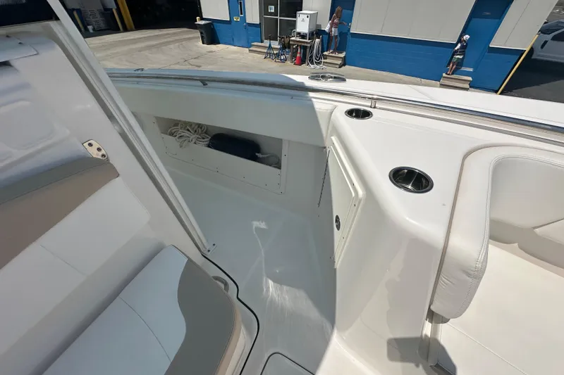 Slide: The Image of 2023 Robalo R302 Center Console boat interior with storage and seating. - 18