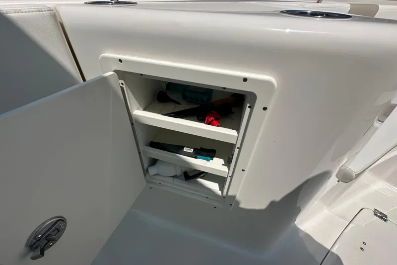 Slide: The Image of Open storage compartment on 2023 Robalo R302 Center Console boat. - 23