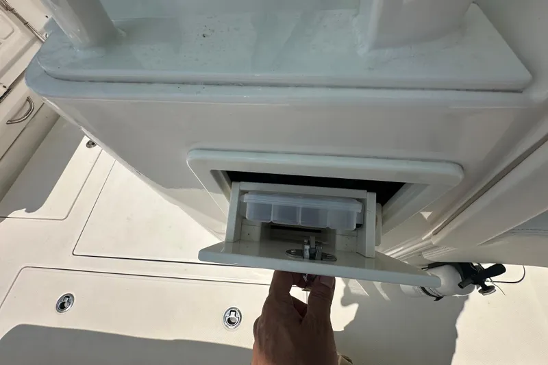 Slide: The Image of 2023 Robalo R302 Center Console storage compartment with open drawer. - 35