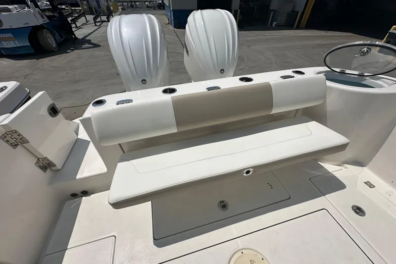 Slide: The Image of 2023 Robalo R302 Center Console boat interior with seating and dual engines. - 36