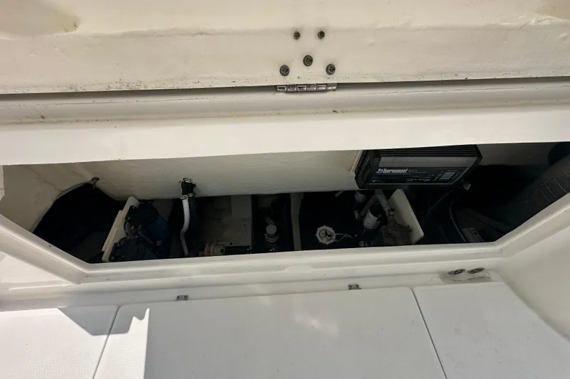 Slide: The Image of 2023 Robalo R302 Center Console boat storage compartment with equipment and wiring. - 37