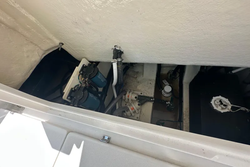 Slide: The Image of 2023 Robalo R302 Center Console boat engine compartment with visible components and wiring. - 38