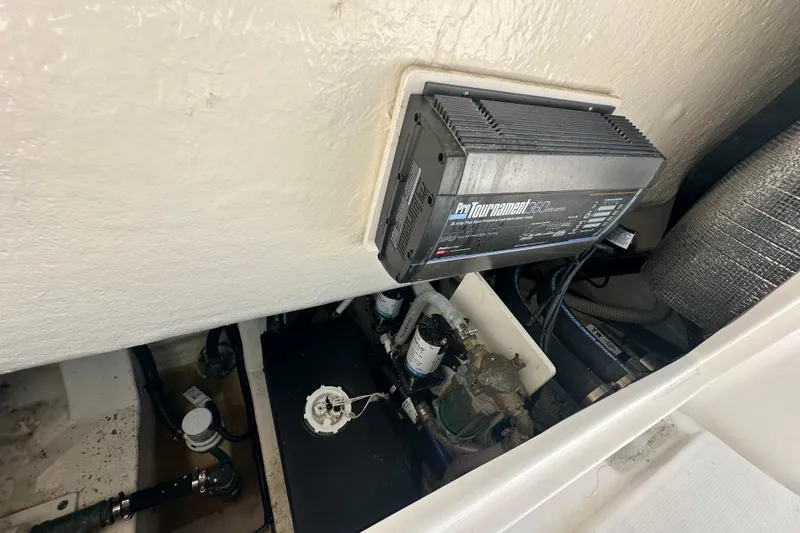 Slide: The Image of 2023 Robalo R302 Center Console boat engine compartment with ProTournament 360 charger. - 39