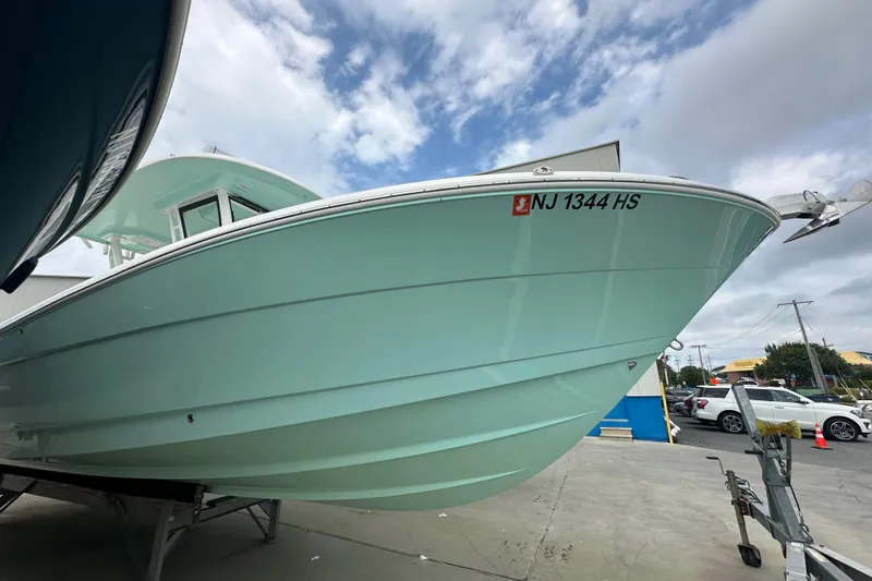 Slide: The Image of 2023 Robalo R302 Center Console boat on display, showcasing sleek design and modern features. - 4