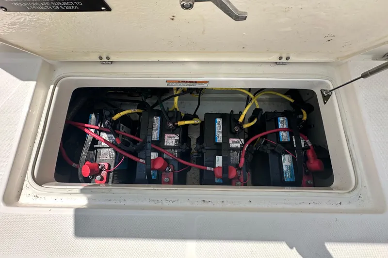 Slide: The Image of 2023 Robalo R302 Center Console boat battery compartment with multiple batteries. - 40