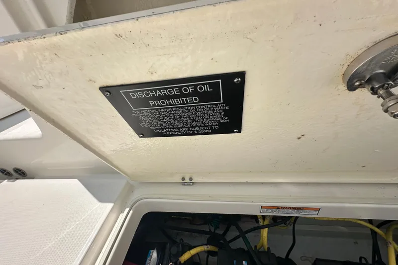 Slide: The Image of 2023 Robalo R302 Center Console boat with "Discharge of Oil Prohibited" sign. - 41