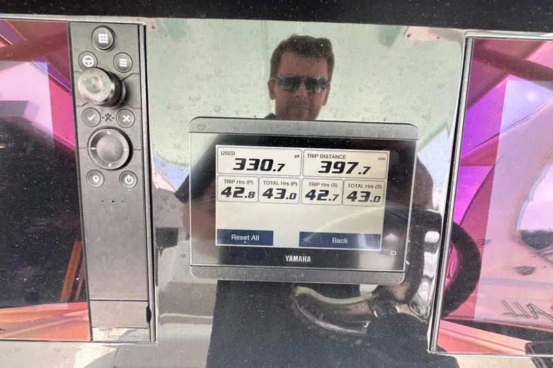 Slide: The Image of 2023 Robalo R302 Center Console dashboard with Yamaha display showing trip data. - 45