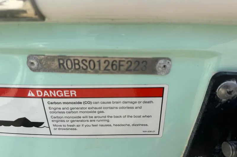 Slide: The Image of 2023 Robalo R302 Center Console boat with carbon monoxide warning label. - 47