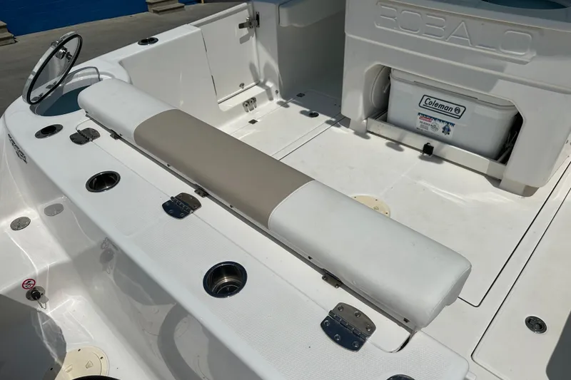 Slide: The Image of 2023 Robalo R302 Center Console boat interior with seating and storage. - 5