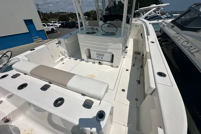 Slide: The Image of 2023 Robalo R302 Center Console boat interior with seating and storage compartments. - 6