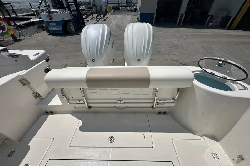 Slide: The Image of 2023 Robalo R302 Center Console boat with dual engines at a dock. - 8