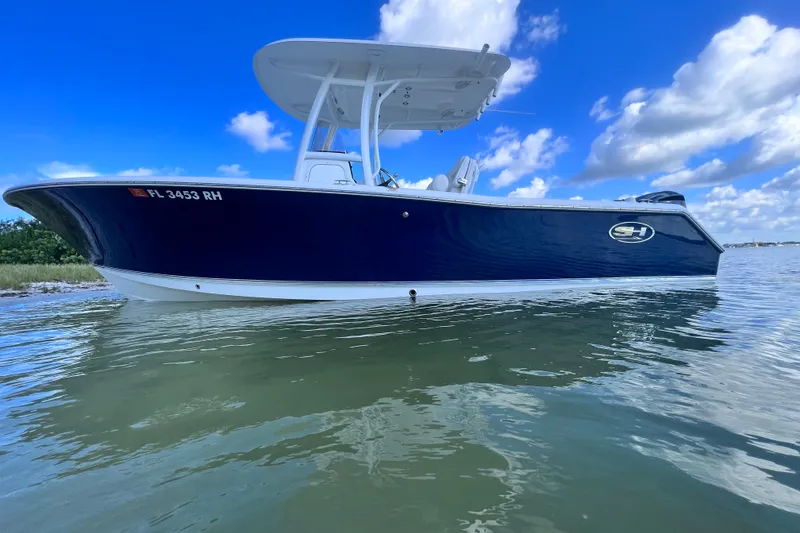 The Image of 2017 Sea Hunt Ultra 235 SE boat on calm water under blue sky. - 0