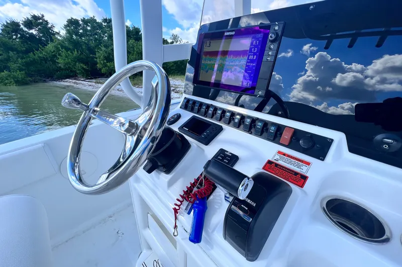 Slide: The Image of Steering console of 2017 Sea Hunt Ultra 235 SE boat with navigation display. - 10