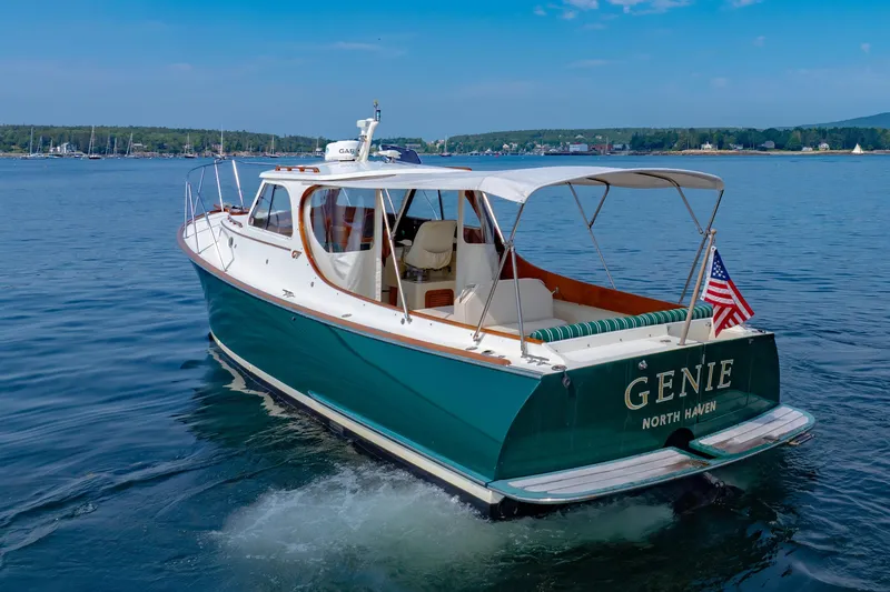 Slide: The Image of 1999 Hinckley Picnic Boat cruising on calm waters with American flag. - 17