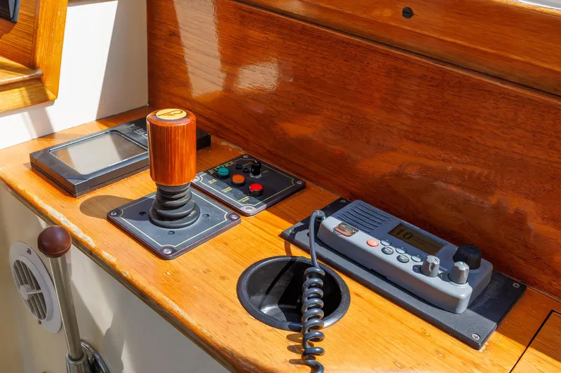 Slide: The Image of 1999 Hinckley Picnic Boat control panel with joystick and communication device. - 30