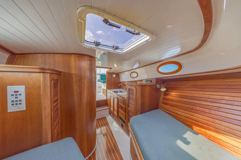 Slide: The Image of Interior of a 1999 Hinckley Picnic Boat with wooden finishes and skylight. - 39