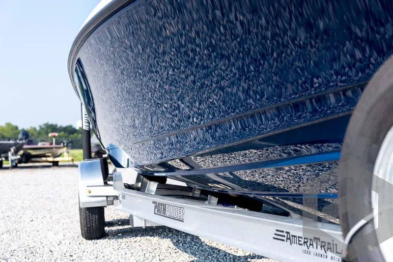 Slide: The Image of 2026 Pathfinder 2200 TRS boat on trailer, close-up view of hull and wheel. - 10