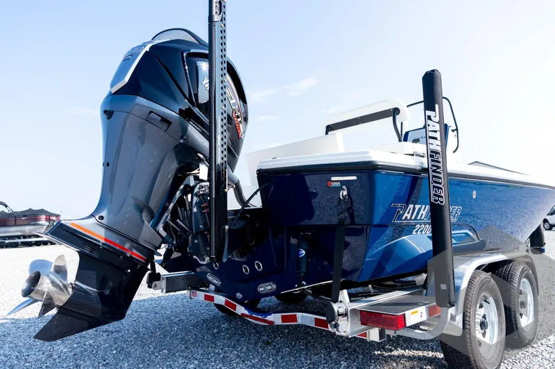Slide: The Image of 2026 Pathfinder 2200 TRS boat with powerful outboard motor on a trailer. - 17