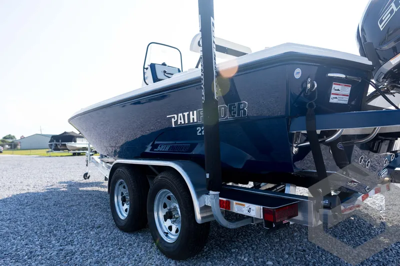 Slide: The Image of 2026 Pathfinder 2200 TRS boat on trailer, parked on gravel lot. - 28