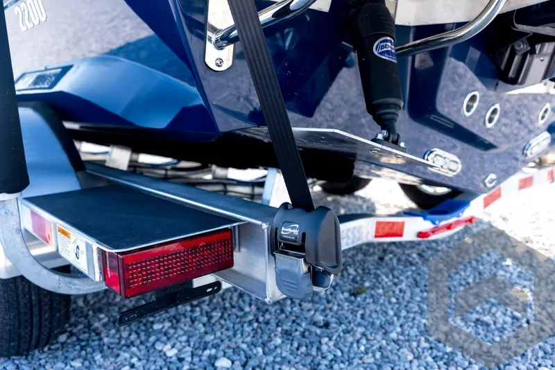 Slide: The Image of 2026 Pathfinder 2200 TRS boat trailer with secure tie-downs and reflective lights. - 32