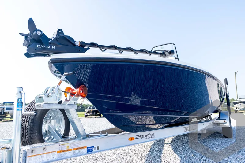 Slide: The Image of 2026 Pathfinder 2200 TRS boat on trailer, featuring Garmin equipment, parked on gravel. - 33