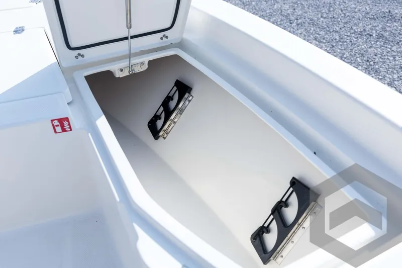 Slide: The Image of Open storage compartment on 2026 Pathfinder 2200 TRS boat, featuring secure latches. - 41