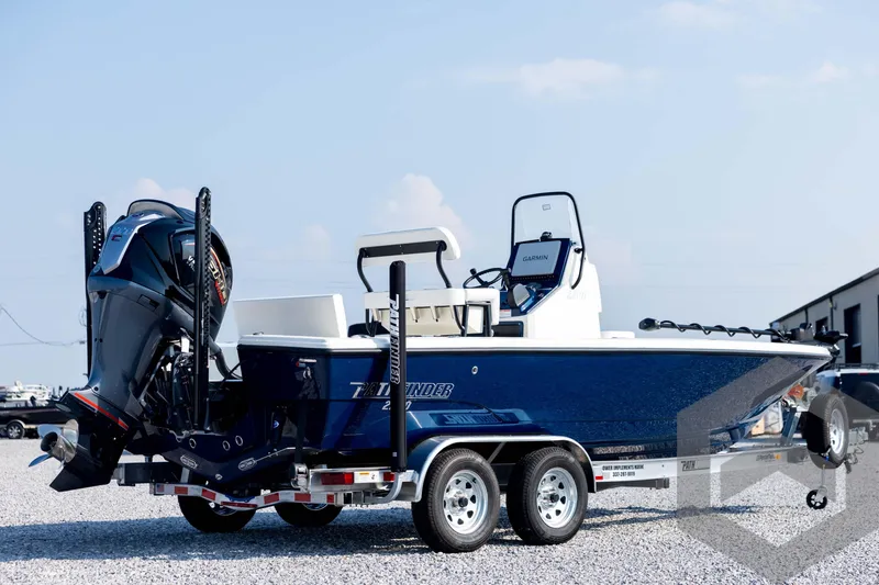 Slide: The Image of 2026 Pathfinder 2200 TRS boat on trailer, featuring sleek design and powerful outboard motor. - 5