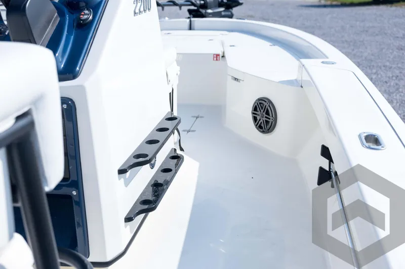 Slide: The Image of 2026 Pathfinder 2200 TRS boat interior with rod holders and speaker. - 53