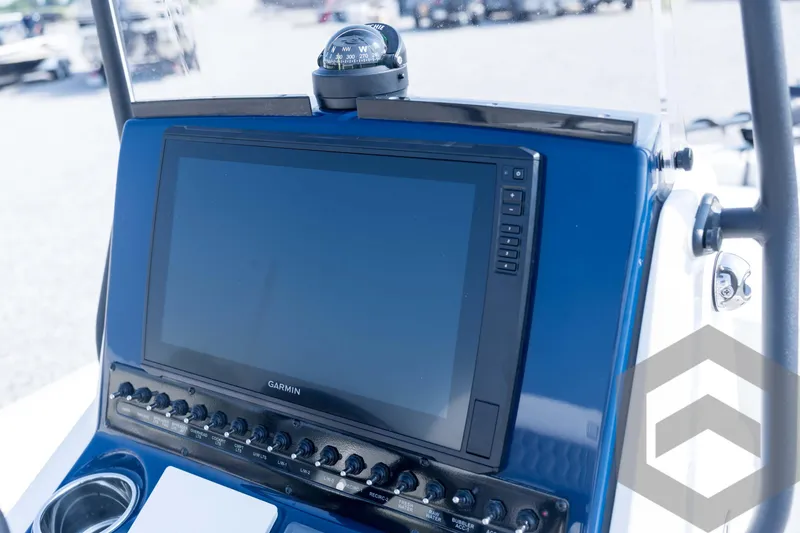 Slide: The Image of 2026 Pathfinder 2200 TRS boat dashboard with Garmin navigation system and compass. - 57