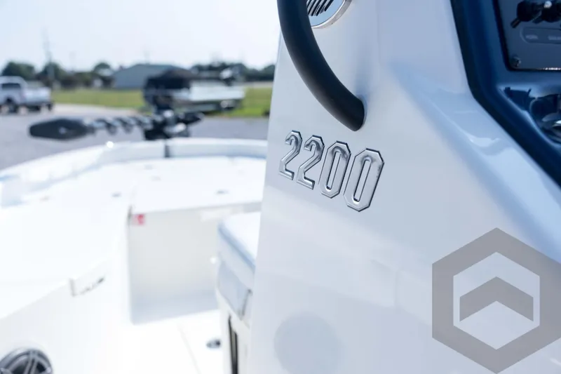 Slide: The Image of 2026 Pathfinder 2200 TRS boat, close-up of model number on sleek white surface. - 63