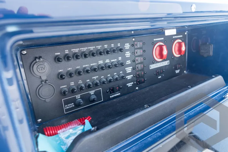 Slide: The Image of Electrical control panel of 2026 Pathfinder 2200 TRS boat, featuring switches and circuit breakers. - 64